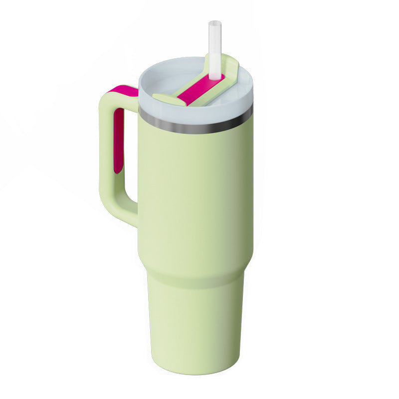 Mint green travel mug with pink handle and straw lid for home and kitchen use