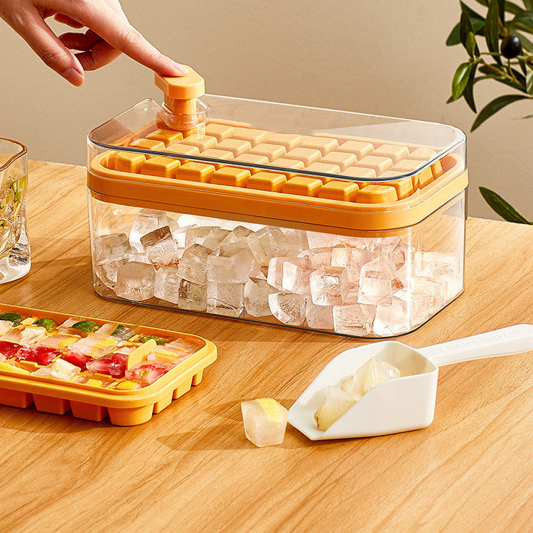 Orange ice cube maker with clear storage bin, perfect for kitchen organization and drink prep